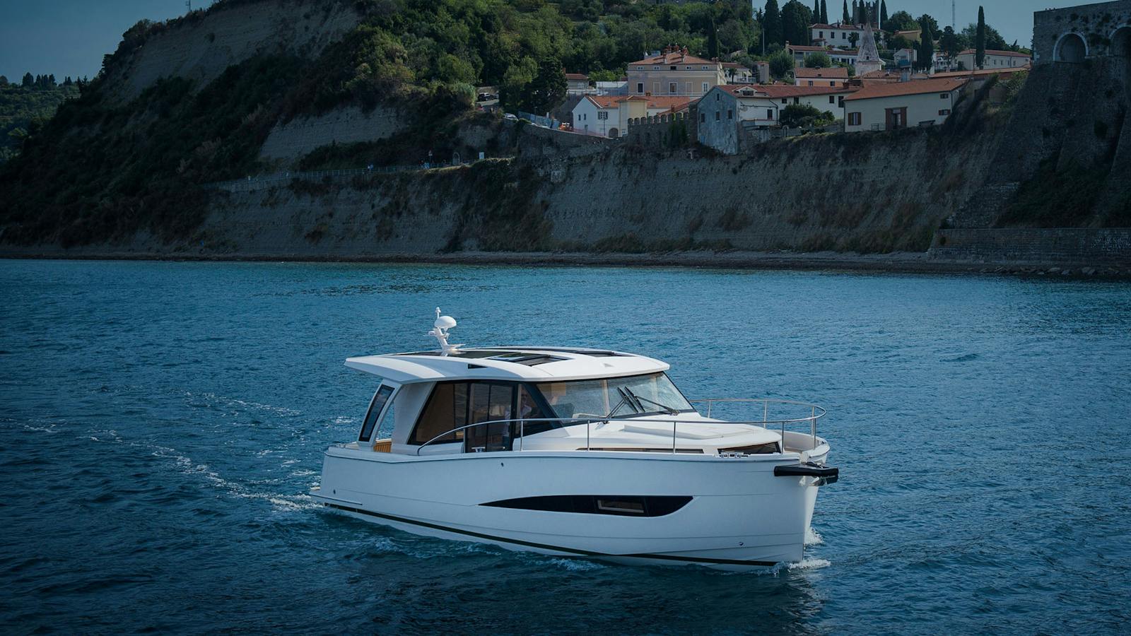 Greenline 39 resting on calm water near the coast