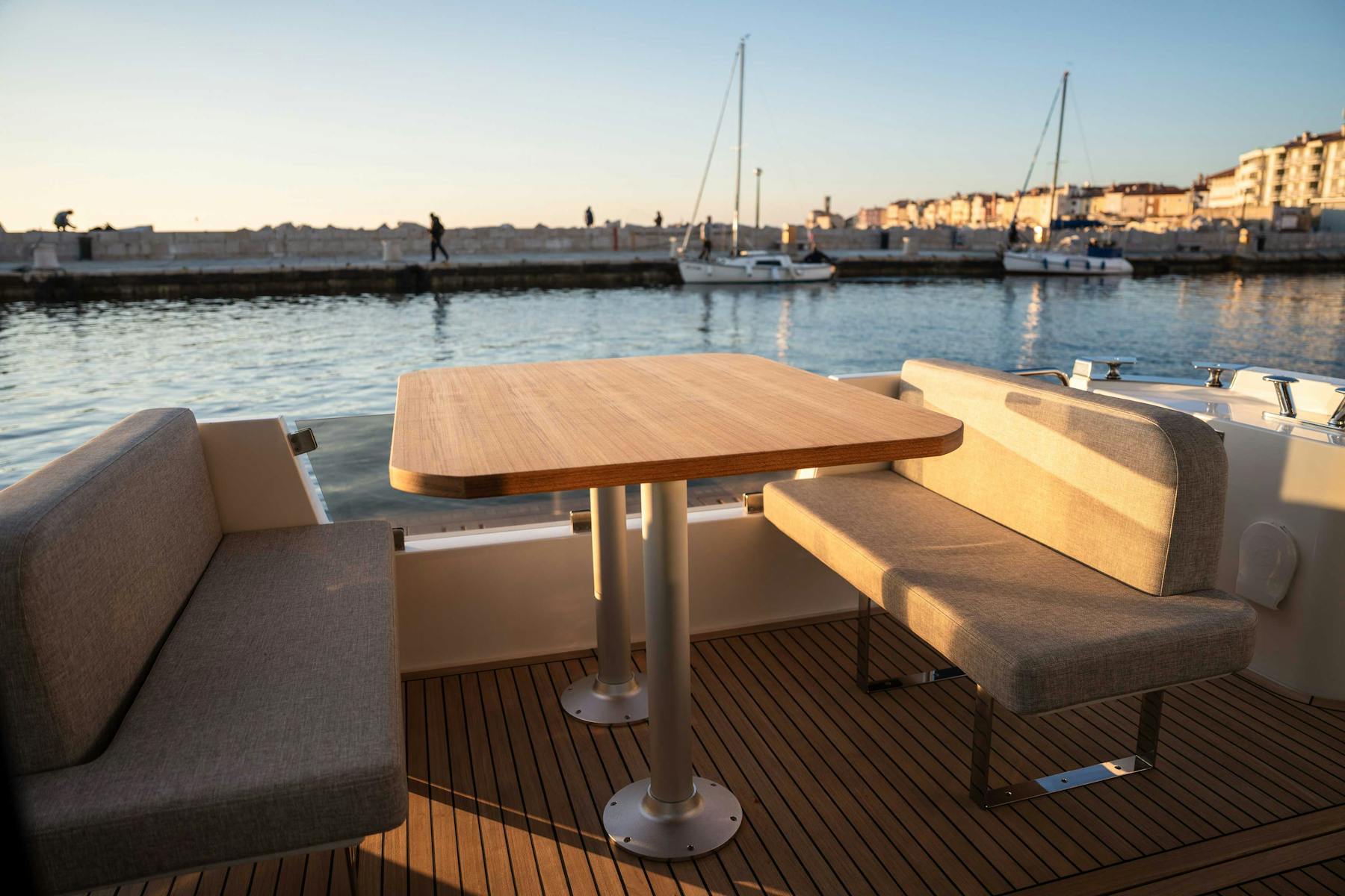Greenline 42 aft cockpit seating and dining table beside the waterfront
